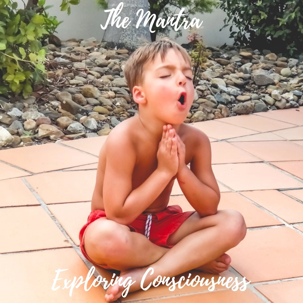 Boy meditating outdoors with hands in prayer position.