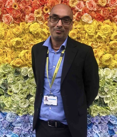 Vikas Pandey against the rainbow rose wall at Watford General Hospital. 2020